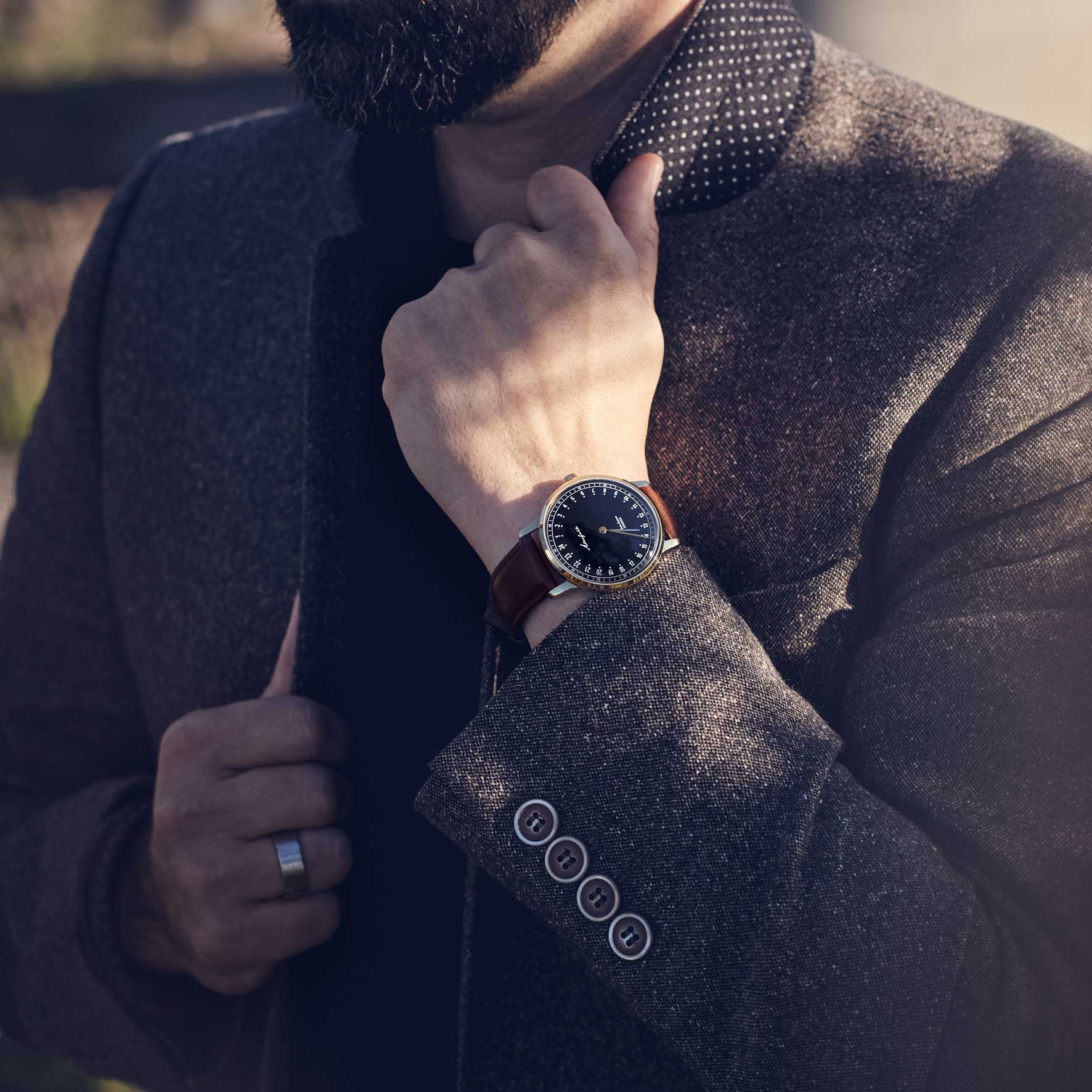 24-hour watch with gold case and brown leather strap